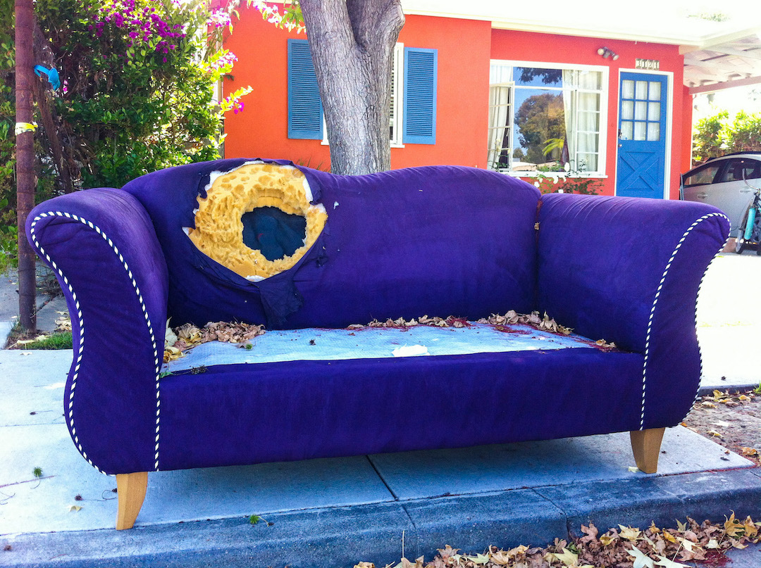 purple  couch on curb