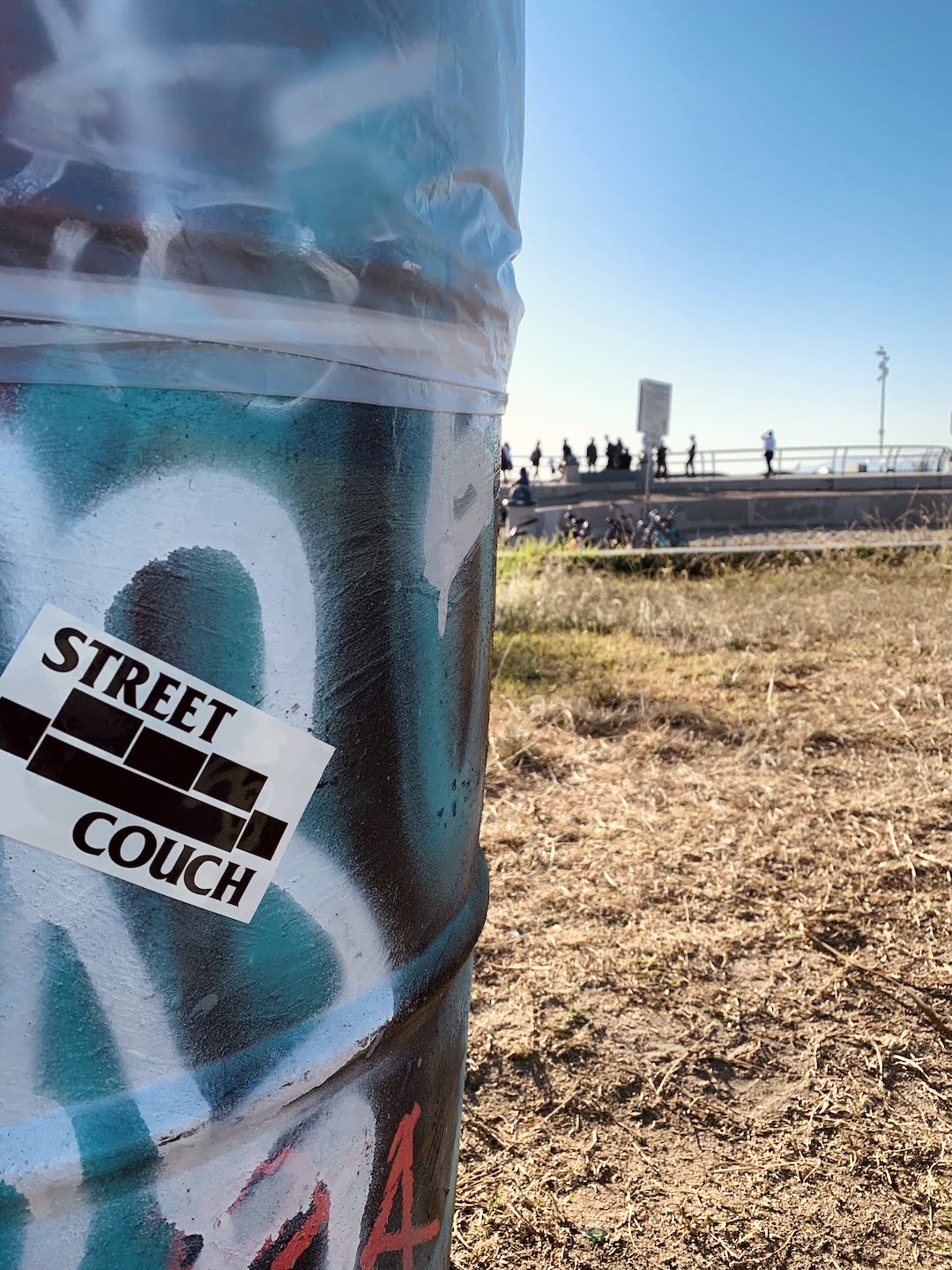 street couch sticker and graffiti on trash can at venice skate park